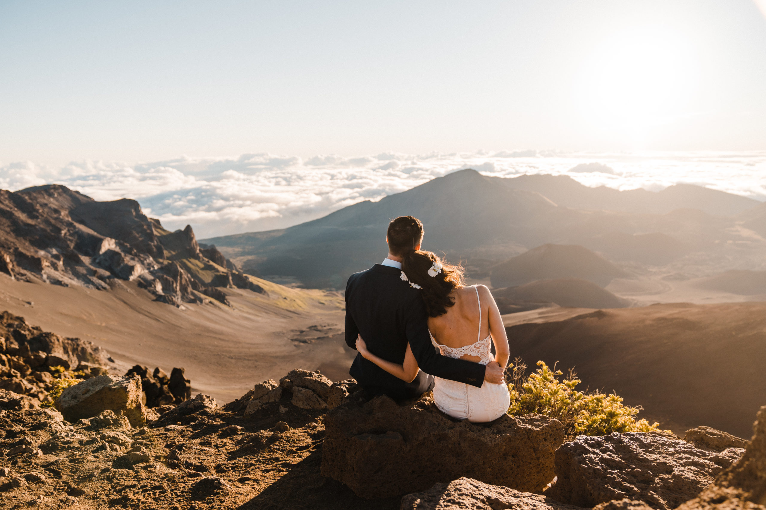 wedding couple watching sunrise in haleakala national park