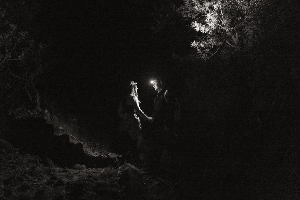 bride and groom hiking to elopement location in hawaii