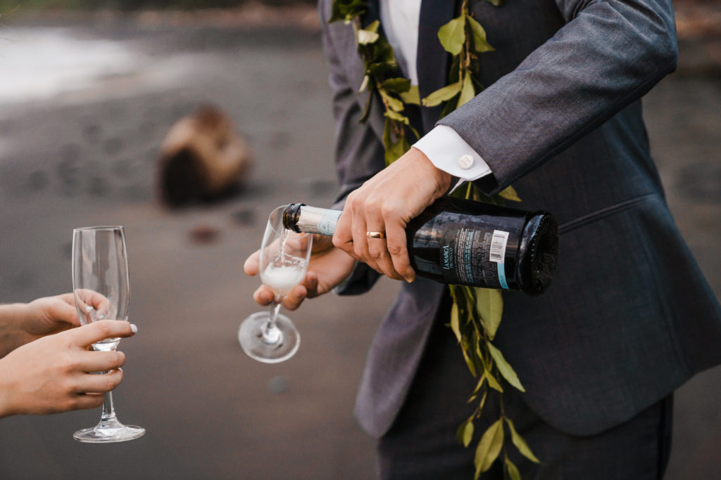 groom pouring champagne