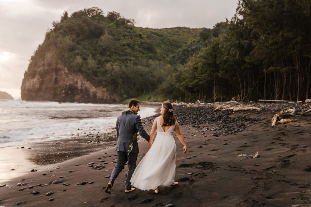 bride and groom walking in pololu valley big island hawaii