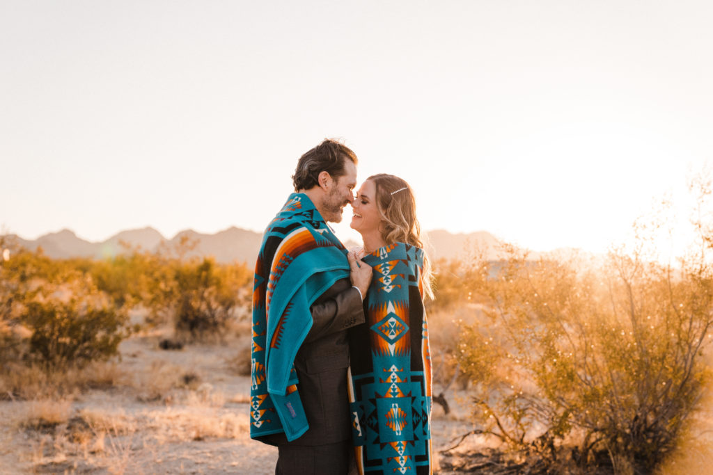 joshua tree bride and groom in wedding blanket